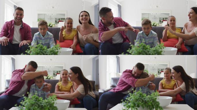 大笑的白种人父母，儿子和女儿一起在家里的沙发上看电视