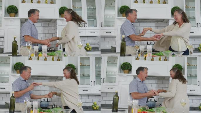 快乐的老年白人夫妇在厨房里开心地跳舞和微笑