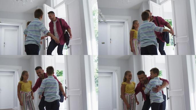 兴奋的白人儿子和女儿在家里跑着，拥抱着父亲从前门进来