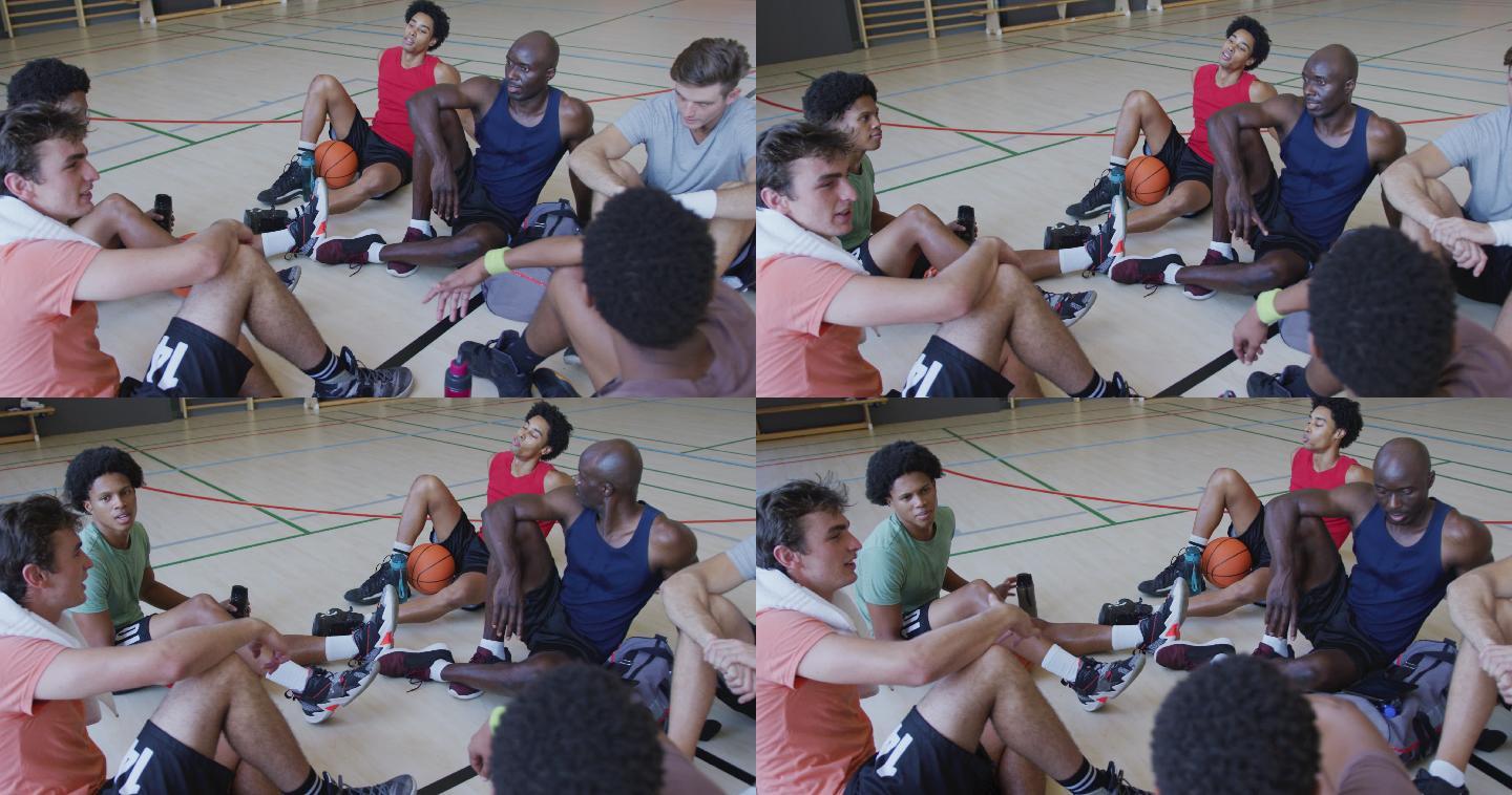 多样化的男子篮球队和教练赛后休息和交谈