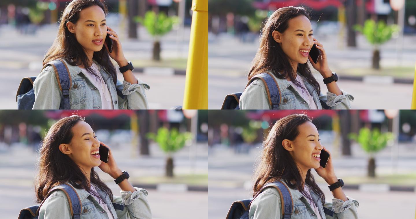 亚洲女性用智能手机聊天，面带微笑