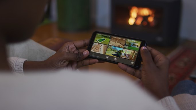 非洲裔美国女人躺在沙发上使用智能手机的手