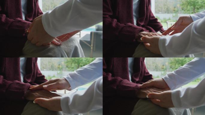 亚洲女性理疗师在手术中治疗老年女性病人的手的上腹部