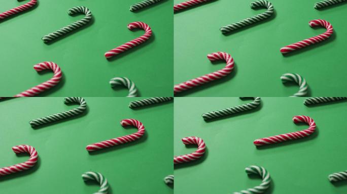 红色和绿色条纹糖果手杖在绿色的背景