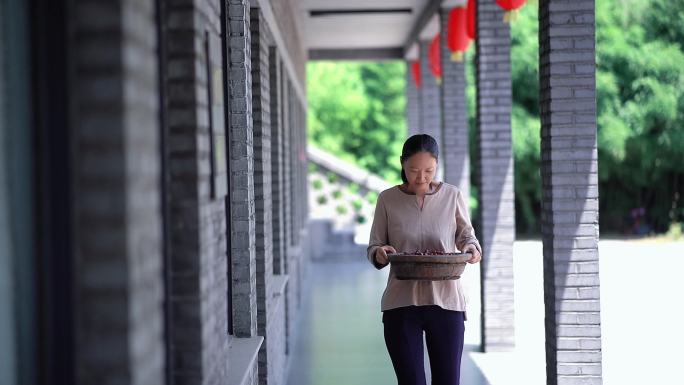 4K实拍女人端着一盆枣走来