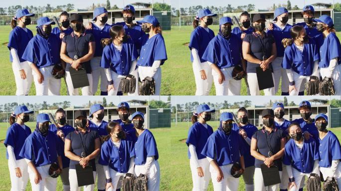 在阳光明媚的球场上，戴着口罩的女棒球队员和教练组成了不同的队伍
