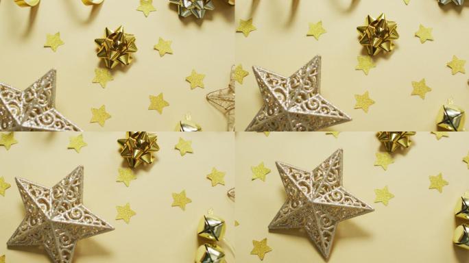 视频的黄金圣诞装饰与黄色背景上的星星