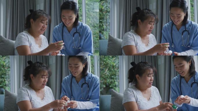 微笑的亚洲女医生与快乐的女病人谈论她的药物在医院
