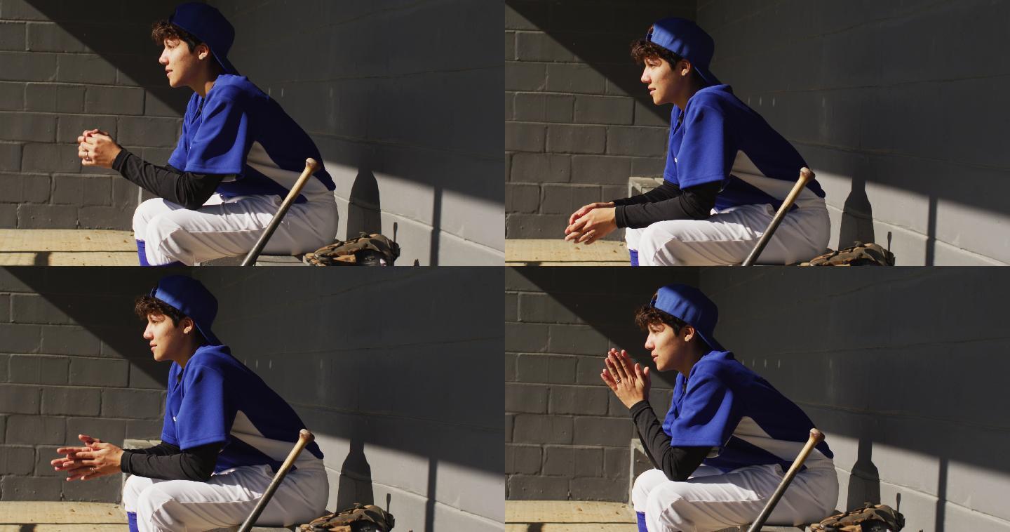 紧张的混血女棒球运动员，坐在板凳上，在阳光下等待棒球球