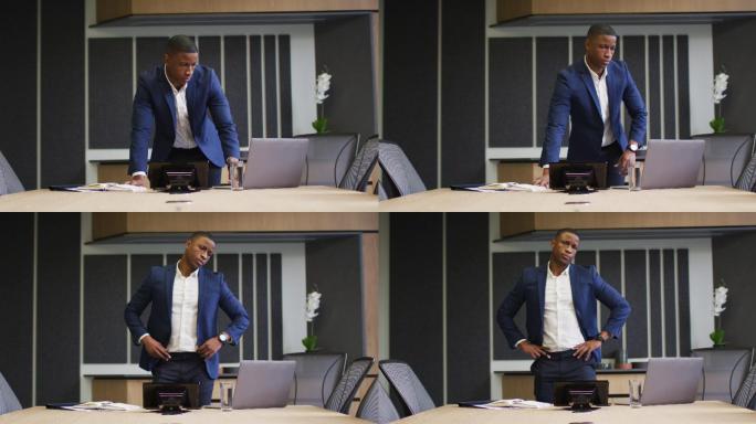 非裔美国商人在现代办公室的会议室使用笔记本电脑