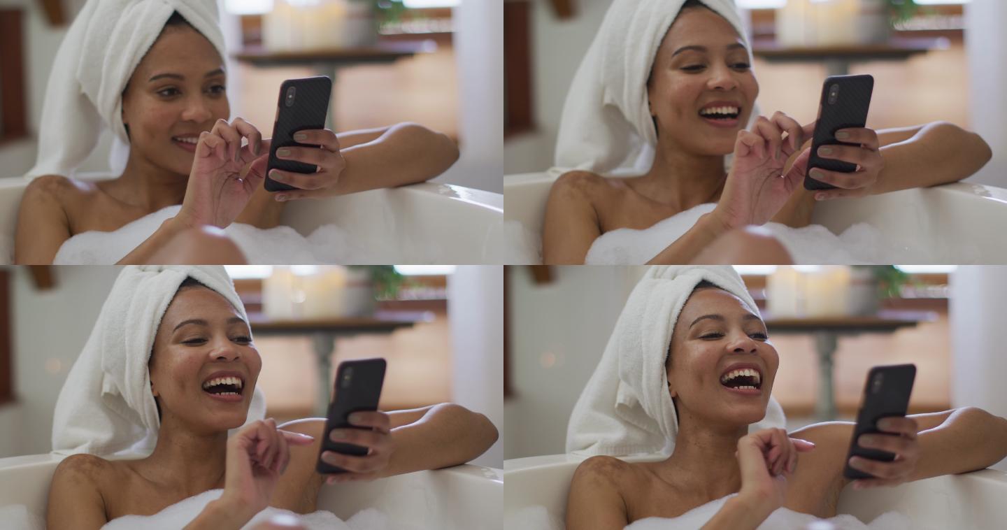 混血妇女洗澡和使用智能手机