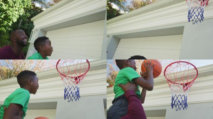非裔美国爸爸抱着他的儿子在篮筐里灌篮