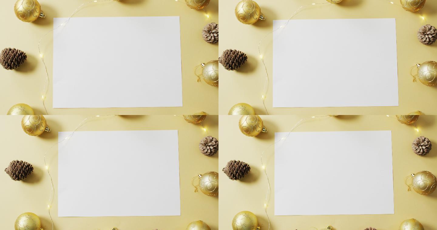 圣诞装饰的视频与一张白纸在黄色的背景