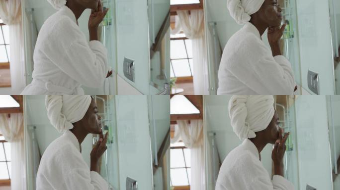 非裔美国美女在浴室里涂面霜