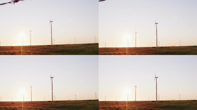 在日落时分万里无云的乡村风景中，风力涡轮机