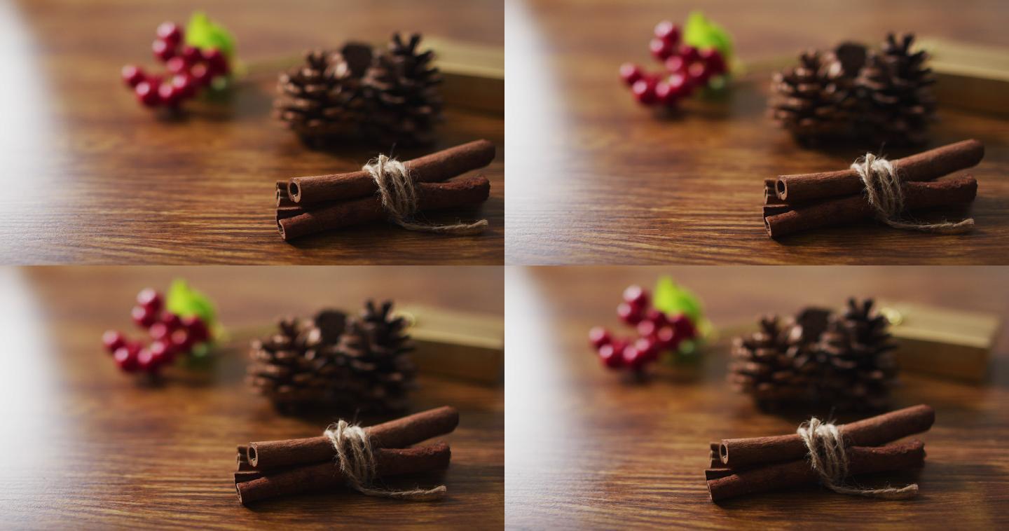 圣诞装饰的视频松果，肉桂和红色浆果在木制背景