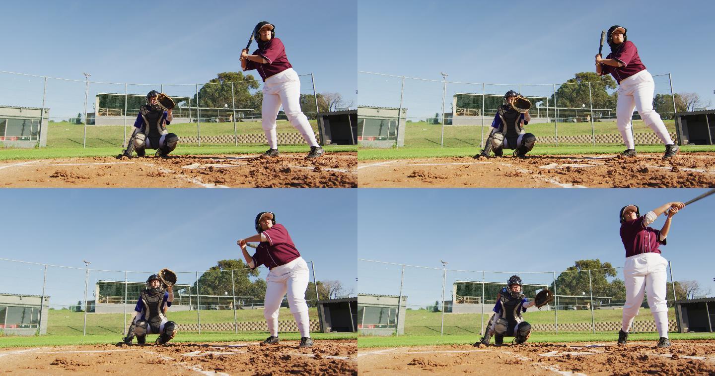 不同组别的女棒球运动员在球场上打球，击球手为投球而摇摆