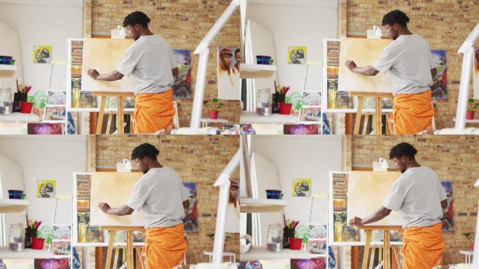 非裔美国男性画家在艺术家工作室的帆布上作画