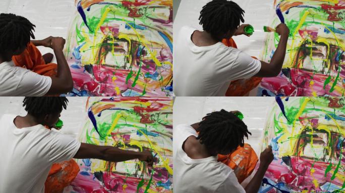 头顶视图的非裔美国男性艺术家倒油漆与画布上的画笔