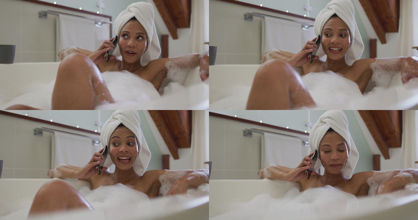 混血儿妇女洗澡和通话的智能手机