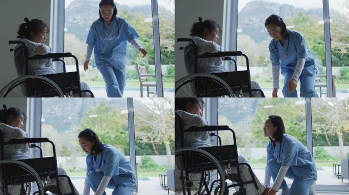 亚洲女医生与轮椅上的女病人交谈，并在医院安排她的脚