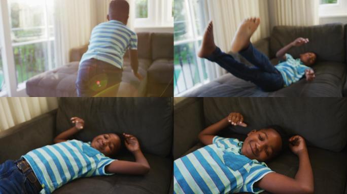 微笑的非洲裔美国男孩在家里的沙发上跳来跳去