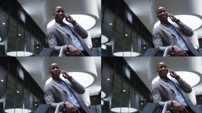 非裔美国商人在现代办公大厅使用智能手机