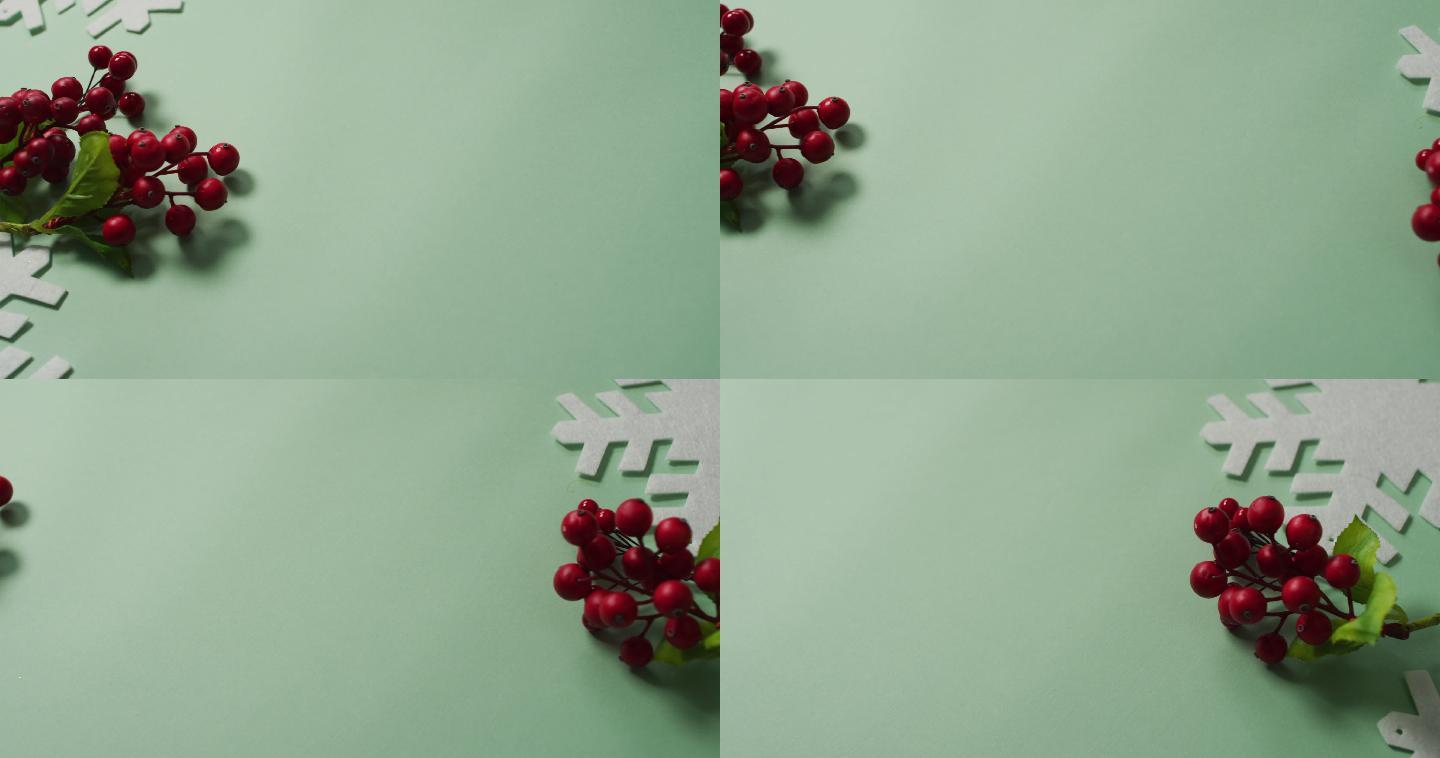圣诞树叶和红色浆果装饰与雪花图案和拷贝空间上的绿色
