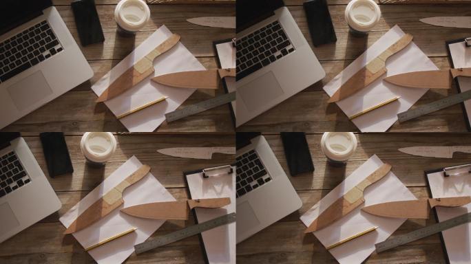 刀匠车间，桌上放着平板电脑、智能手机、木刀和纸