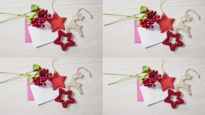 圣诞装饰的视频，红色的浆果和白色和粉红色的卡片在木制的背景上