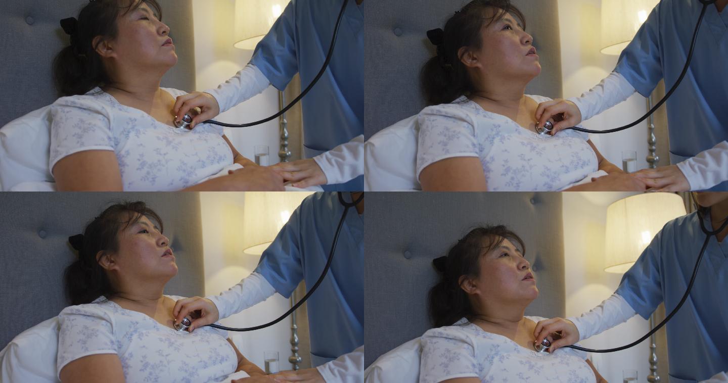 亚洲女医生用听诊器检查躺在病床上的女病人
