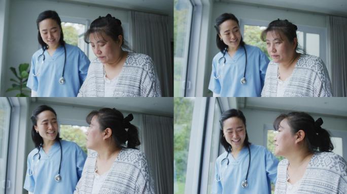 微笑的亚洲女医生在医院帮助快乐的女病人用步行架行走
