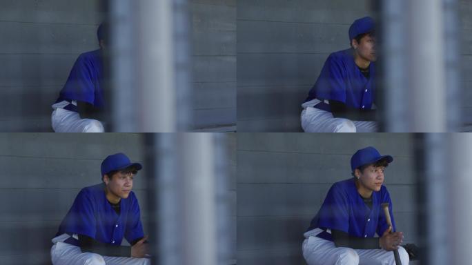 紧张的混血女棒球运动员，坐在板凳上等待，拿着棒球球