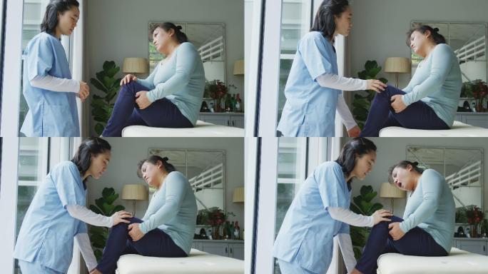 亚洲女性理疗师治疗女性患者在手术中抱膝疼痛