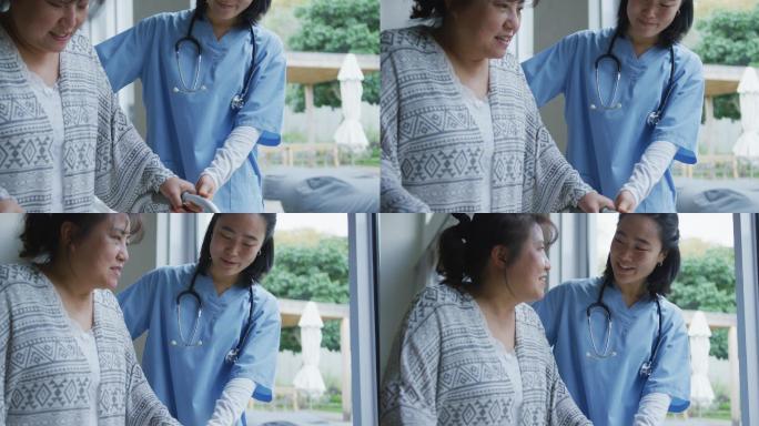 微笑的亚洲女医生在医院帮助快乐的女病人用步行架行走