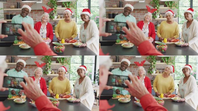 圣诞节期间，一群快乐的不同年龄的朋友在一起烹饪和自拍