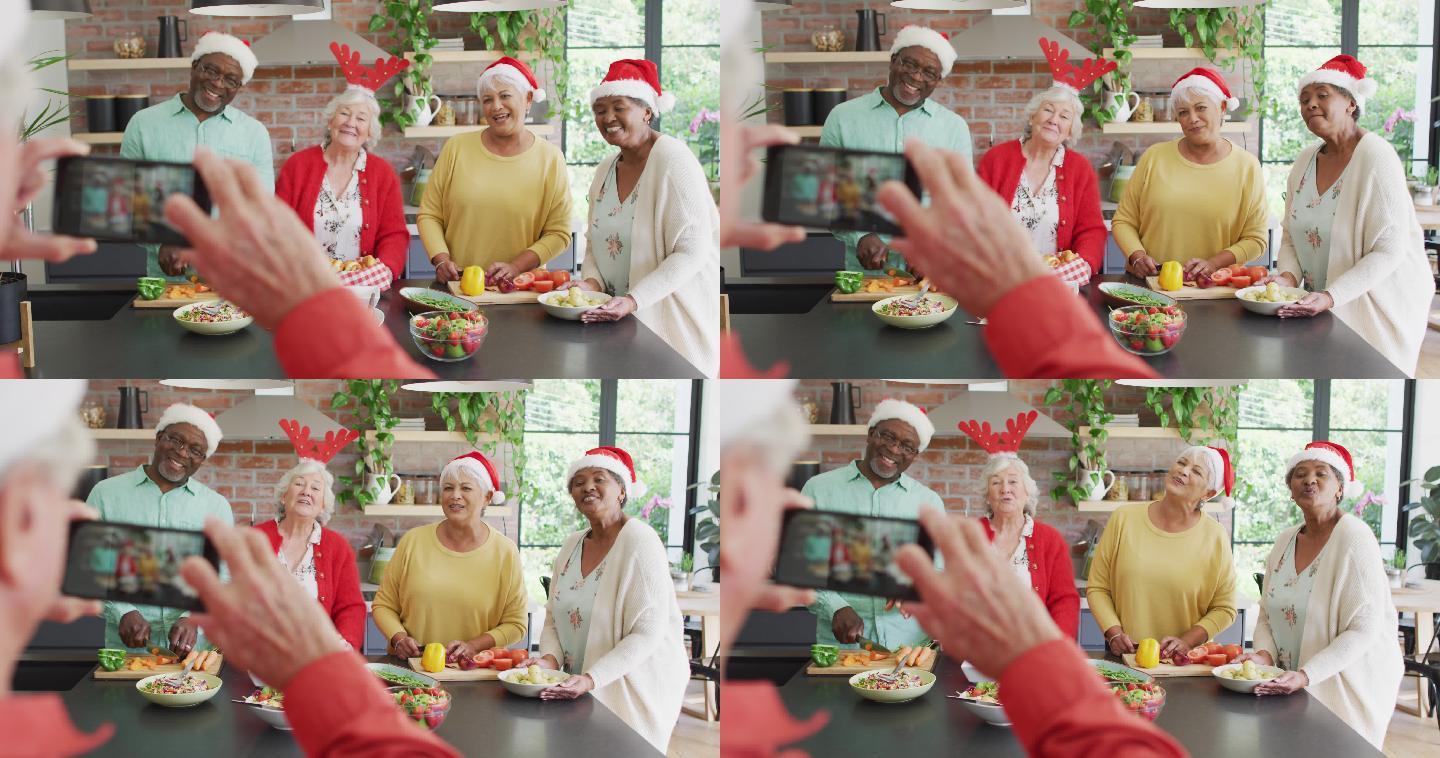 圣诞节期间，一群快乐的不同年龄的朋友在一起烹饪和自拍