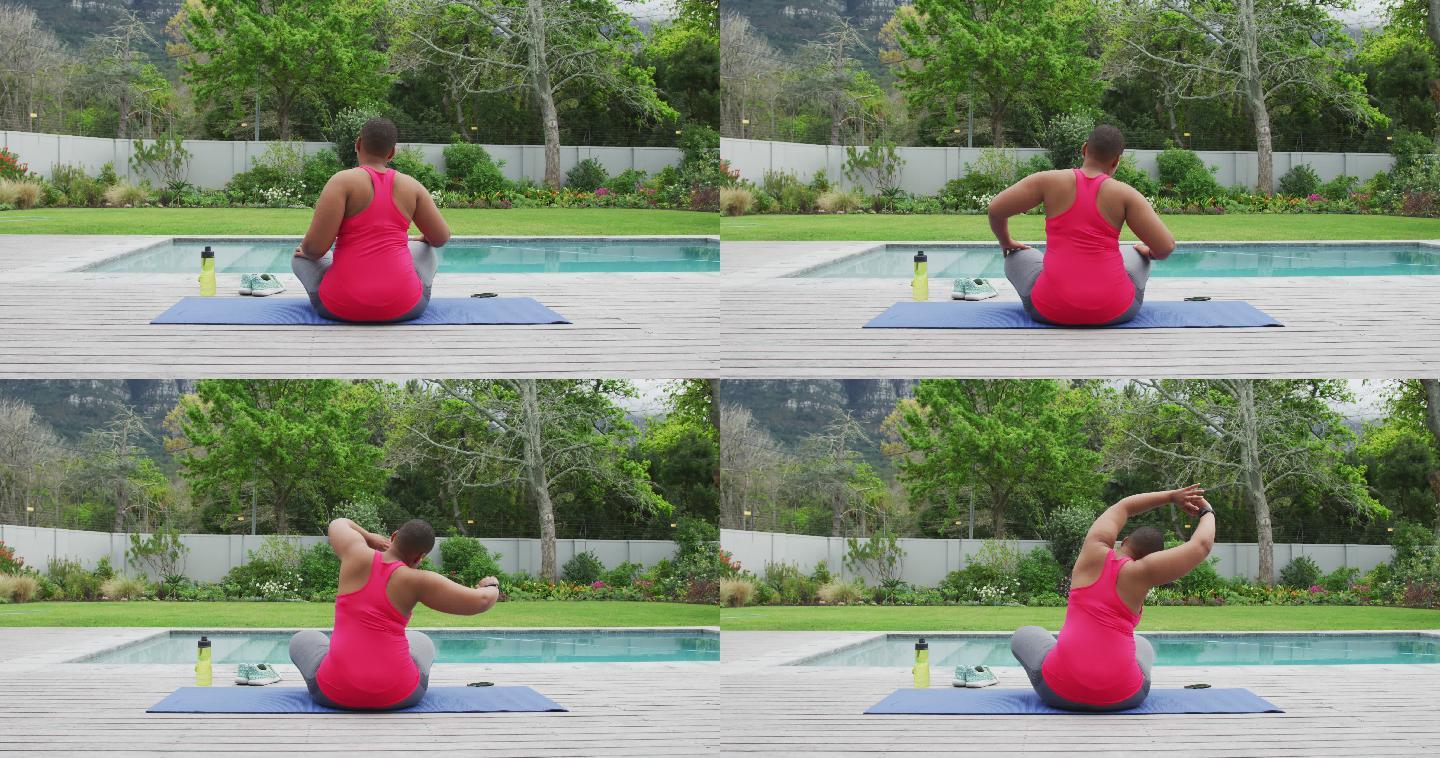 快乐的非裔美国胖女人练习瑜伽，在花园里的游泳池边伸展身体