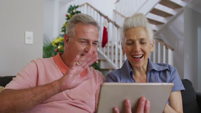 快乐的白种人老夫妇在圣诞节视频通话