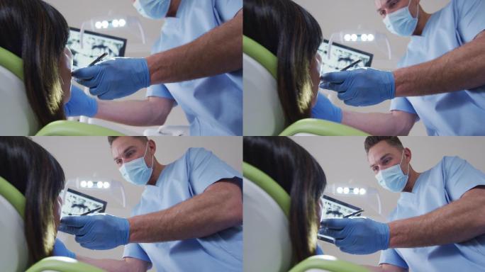 在现代牙科诊所，白人男性牙医带着口罩为女性病人检查牙齿