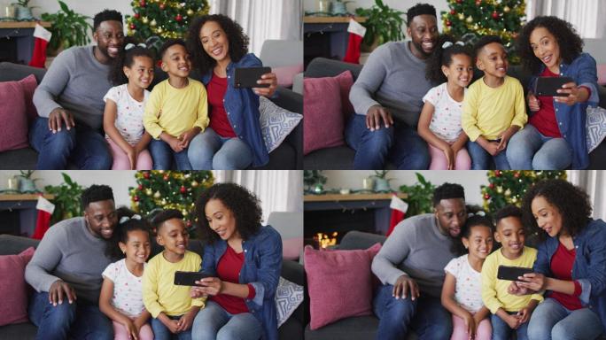 微笑的非裔美国家庭在自拍，背景是圣诞装饰