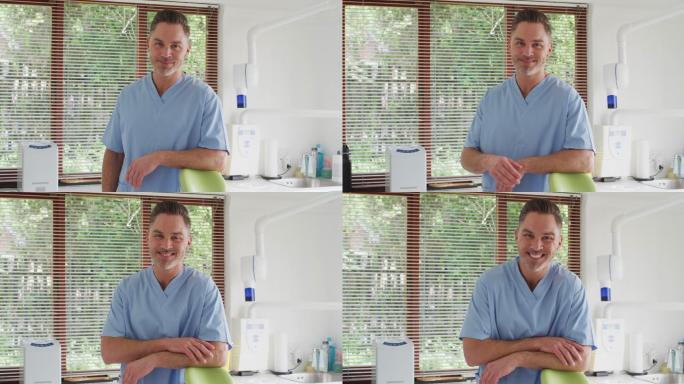 微笑的白人男性牙医的肖像看着镜头在现代牙科诊所