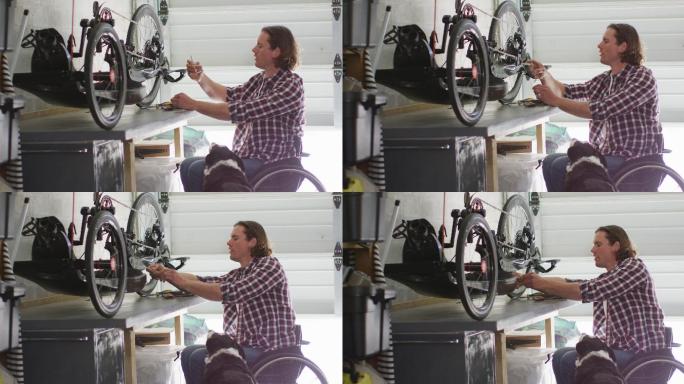 重点高加索残疾人在轮椅修理自行车在车库