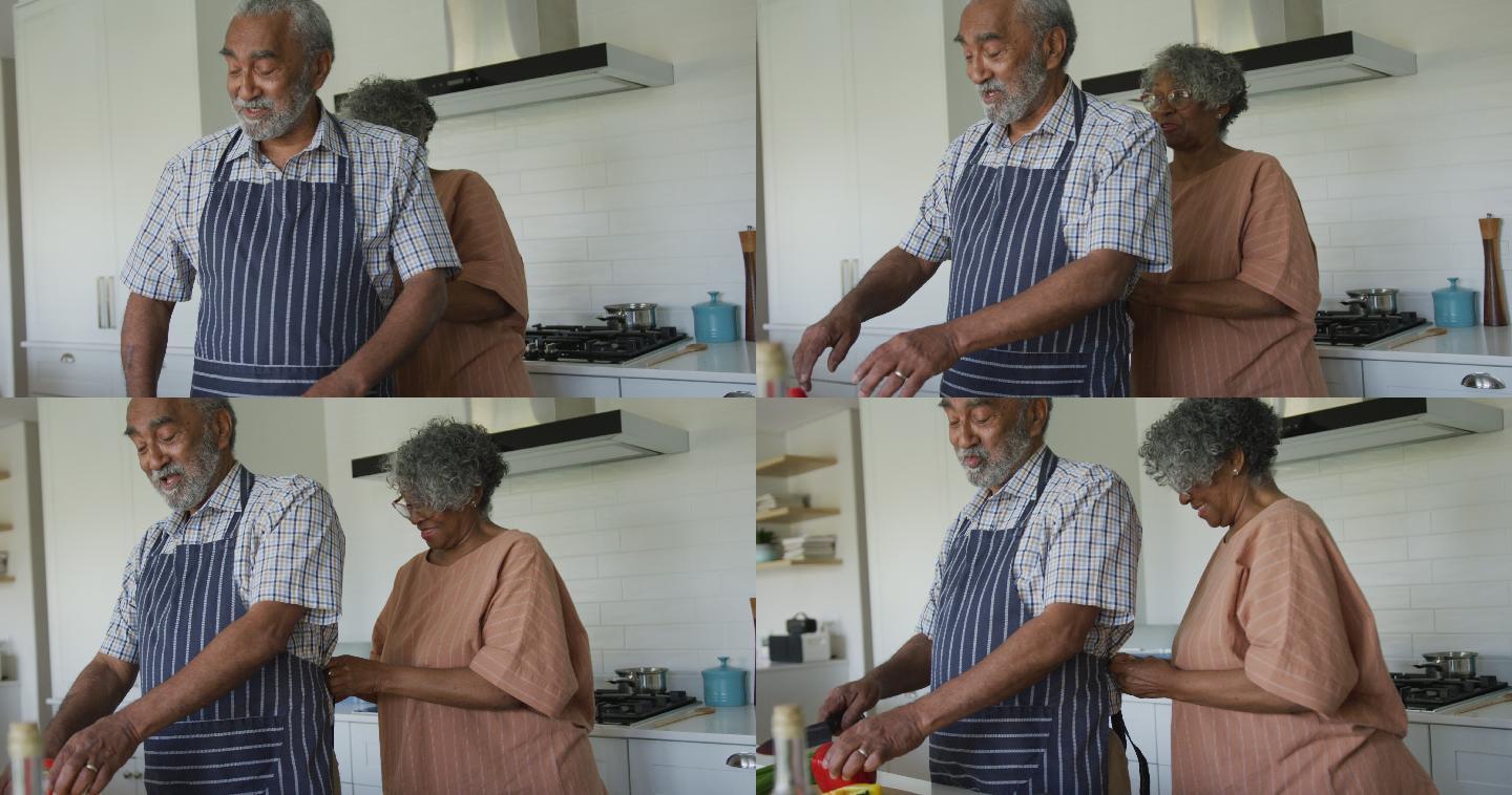 快乐的非裔美国老夫妇在厨房一起做饭