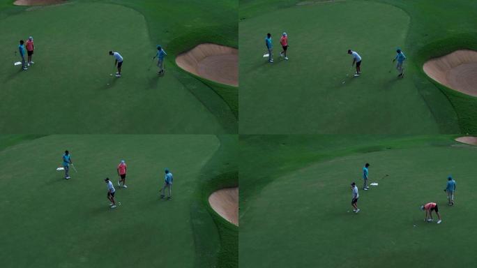 四位高尔夫球员击球入洞