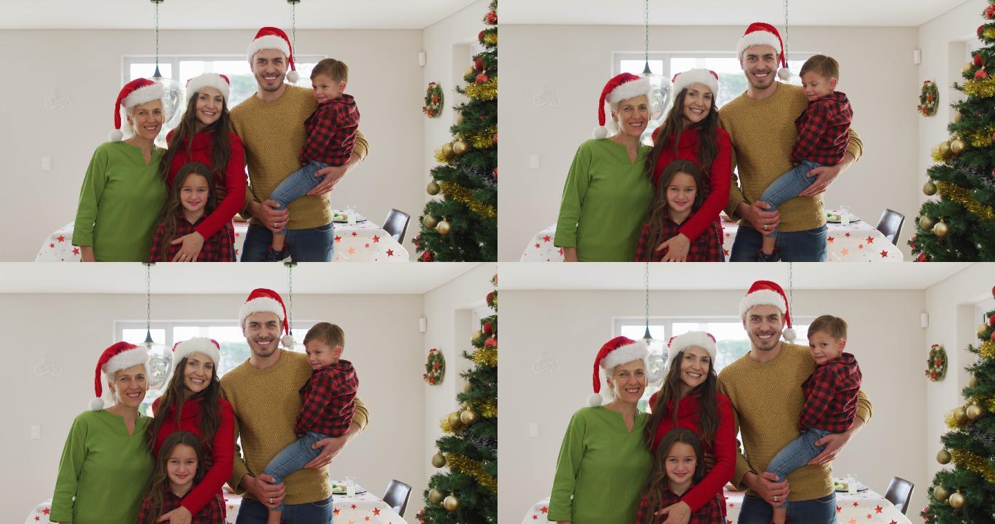 快乐的白种人多代家庭戴着圣诞帽，看着镜头