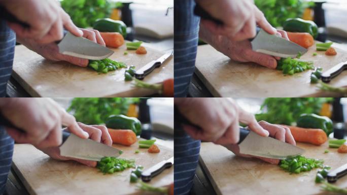 男子在切菜板上切青椒的特写