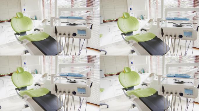 牙科诊所的室内空荡荡，配有绿色的牙科椅和工具