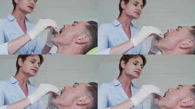 白人女牙科护士在现代牙科诊所检查男性病人的牙齿