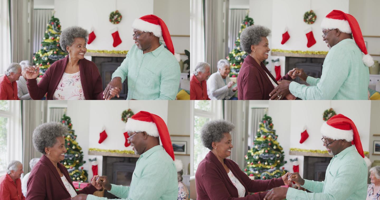 快乐的非裔美国老年夫妇和朋友在圣诞期间一起跳舞